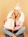 Little backpack and knitted hat. Total pastel outfit. Tender combination. Matching accessories. Neutral color base