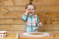 Little baker chef kid at kitchen. Gappy baby child baking cookies. Child cute baby doing homemade bakery in kitchen Royalty Free Stock Photo