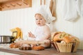 Little baker child in chef hat at kitchen table alone Royalty Free Stock Photo