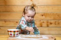 Little baker child at kitchen. Baby boy in the kitchen helping with cooking, playing with flour. Royalty Free Stock Photo