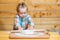 Little baker child at kitchen. Baby boy in the kitchen helping with cooking, playing with flour. Royalty Free Stock Photo