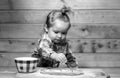 Little baker child at kitchen. Baby boy in the kitchen helping with cooking, playing with flour. Royalty Free Stock Photo