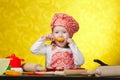 Little baker or cook girl cuts dough for cookies Royalty Free Stock Photo