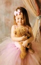 Little ballerina beauty hugging teddy bear Royalty Free Stock Photo