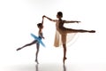 The little ballerina dancing with personal ballet teacher in dance studio