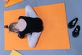 Little ballerina doing exercises and bend, sitting on the floor in the ballet class Royalty Free Stock Photo