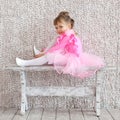 Little ballerina girl in ballet pink dress. Rehearsal