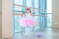 Little ballerina girl in a pink tutu. Adorable child dancing classical ballet in a white studio. Children dance. Kids Royalty Free Stock Photo