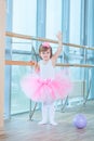 Little ballerina girl in a pink tutu. Adorable child dancing classical ballet in a white studio. Children dance. Kids Royalty Free Stock Photo