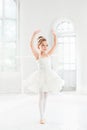 Little ballerina girl in a tutu. Adorable child dancing classical ballet in a white studio. Royalty Free Stock Photo