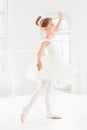 Little ballerina girl in a tutu. Adorable child dancing classical ballet in a white studio. Royalty Free Stock Photo