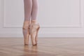 Little ballerina practicing dance moves in studio, closeup of legs. Space for text Royalty Free Stock Photo