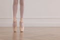 Little ballerina practicing dance moves in studio, closeup of legs. Space for text Royalty Free Stock Photo
