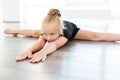 Little ballerina stretching and doing twine in dance studio Royalty Free Stock Photo