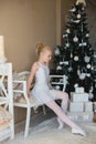 Little ballet dancer doing stretching before exercise