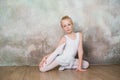 Little ballet dancer doing stretching before exercise