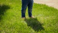 Little barefoot baby boy in jeans standing on green grass lawn. Kids outdoors, children in nature, baby playing outside Royalty Free Stock Photo