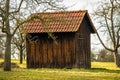 Little barn in a meadow in winter in sun