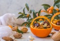 Little basket made of fresh orange filled with dry fruits; almonds, dates, raisins and nuts Royalty Free Stock Photo