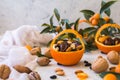 Little basket made of fresh orange filled with dry fruits; almonds, dates, raisins and nuts Royalty Free Stock Photo