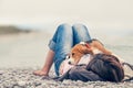 Little beagle puppy lying on his owner chest at the sea side