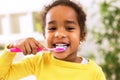 Little beautiful african girl brushing teeth