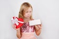 Little beautiful blond girl holding beautiful gift for the Valentines day, Birthday, New Year. Royalty Free Stock Photo