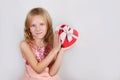 Little beautiful blond girl holding beautiful gift for the Valentines day, Birthday, New Year. Royalty Free Stock Photo