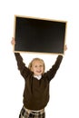 Little beautiful blond schoolgirl smiling happy and cheerful holding and showing small blank blackboard