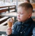 Little beautiful Boy eating ice cream, cafe. Royalty Free Stock Photo