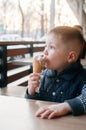 Little beautiful Boy eating ice cream, cafe. Royalty Free Stock Photo