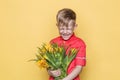 Little beautiful child with pink shirt gives a bouquet of flowers on Women`s Day, Mother`s Day. Birthday. Valentine`s day. Spring. Royalty Free Stock Photo