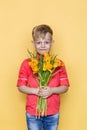 Little beautiful child with pink shirt gives a bouquet of flowers on Women`s Day, Mother`s Day. Birthday. Valentine`s day. Spring. Royalty Free Stock Photo