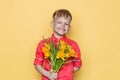 Little beautiful child with pink shirt gives a bouquet of flowers on Women`s Day, Mother`s Day. Birthday. Valentine`s day. Spring. Royalty Free Stock Photo