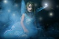 Little beautiful girl in blue dress with wings.