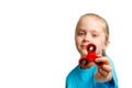 Little beautiful girl in blue t-shirt is playing red spinner in hand