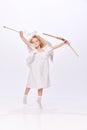 Little beautiful girl, child in image of cupid, angel holding bow isolated over white studio background. Valentines