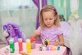 Little beautiful girl draws paints on the table Royalty Free Stock Photo