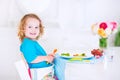 Little beautiful girl eating salad for lunch Royalty Free Stock Photo