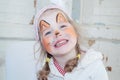 Little beautiful girl with face painting of fox smiles Royalty Free Stock Photo