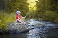 Little Girl Fishing on a Blue River Royalty Free Stock Photo