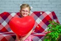 Little beautiful girl in glasses with red gift box heart and balloon. Valentine& x27;s Day holiday. Children& x27;s love. Child Royalty Free Stock Photo