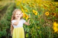 A little beautiful girl holds a sunflower in a field in summer Royalty Free Stock Photo
