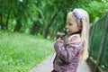 Little beautiful blond girl in nature