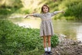 Little girl in nature stream wearing beautiful dress Royalty Free Stock Photo