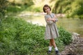 Little girl in nature stream wearing beautiful dress Royalty Free Stock Photo