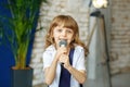 A little beautiful girl sings in a microphone. The concept is ch Royalty Free Stock Photo