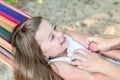 Little beautiful girl sitting in a hammock and smiling Royalty Free Stock Photo