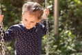 Little beautiful girl smiling swings on a swing in the park Royalty Free Stock Photo