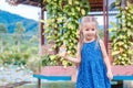 Little beautiful girl standing with a bottle of fish food in hand. Yang Bay Vietnam